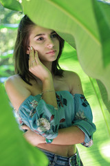 Naklejka premium Sexy young brunette beauty in a rain forest