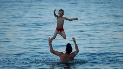 Father lift up son happy child with thumb up, OK sign, slow motion, lay the foundation of strong and trustful relationship