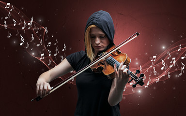 Fototapeta premium Lonely musical composer with violin and sparkling musical notes around