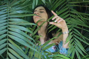 Sexy young brunette beauty in a rain forest