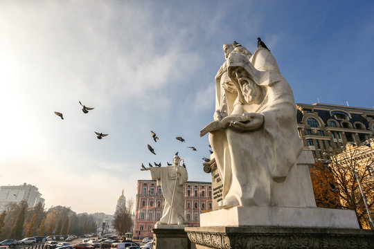 Pigeons fly over Monument to Princess Olga, Saint Andrew, Sts. Cyril and Methodius in Kyiv, Ukraine. 