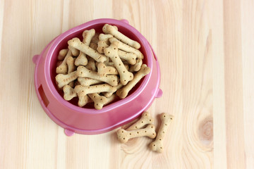 dog food, cookies in a plastic bowl, top view.