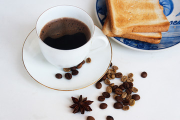 A cup of coffee with toaster bread, beans coffee. Candid.