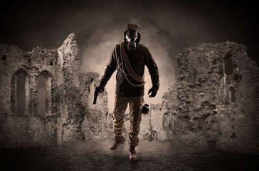 Hazard, menace man in a ruined crumbly building with arms on his hand
