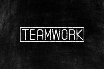 Fototapeta premium Teamwork in Chalk Writing on Old Grunge Chalkboard Background, Suitable for Education and Business Concept.