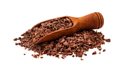 Grated chocolate. Pile of ground chocolate with wooden scoop isolated on white background, closeup