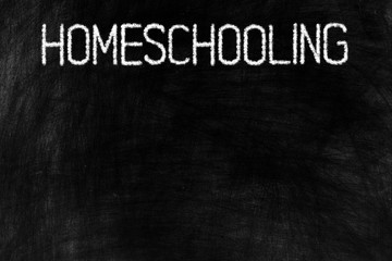 Homeschooling in Chalk Writing on the Top of Old Grunge Chalkboard Background, Suitable for Education Concept.