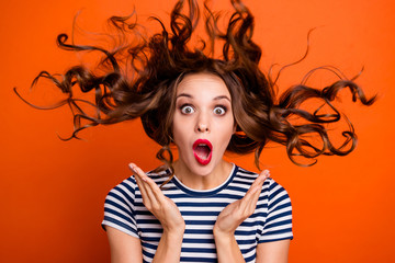 Close up photo beautiful she her lady red lipstick pomade hand arm palm raised hair curls flight unexpected epic fail wear casual striped white blue t-shirt clothes isolated orange bright background