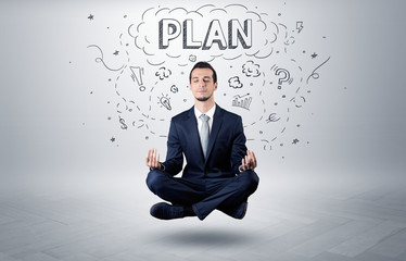Businessman sitting in yoga position and meditates with doodle concept
