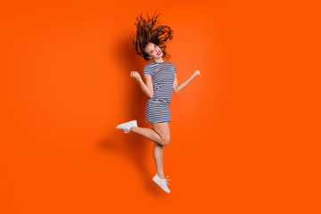 Fototapeta na wymiar Full length body size photo portrait of pretty ecstatic glad optimistic nice charming gorgeous with blowing hairdo she her student lady raising fists hands up isolated vivid background