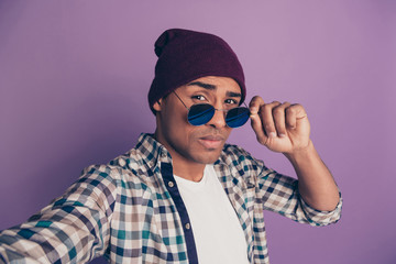 Close up photo portrait of confident modern blogger influencer on instagram making taking picture adjusting round specs isolated violet background