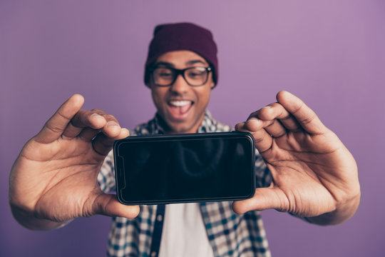 Closeup photo portrait of handsome optimistic positive excited rejoicing blogger having online video call making taking selfie showing touch screen touchscreen isolated violet background