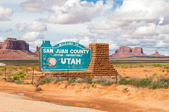Welcome sign in desert for San Juan County in Monument Valley in Utah.