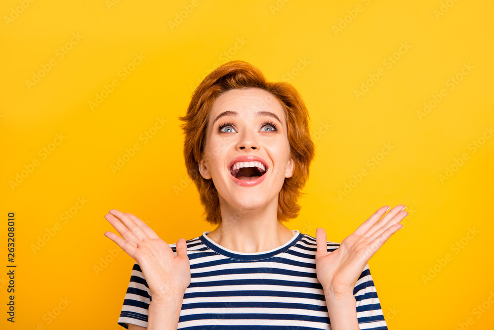 Wall mural Close up photo beautiful she her lady look up empty space unexpected free abroad journey hands arms raised wearing casual striped white blue t-shirt outfit clothes isolated yellow bright background