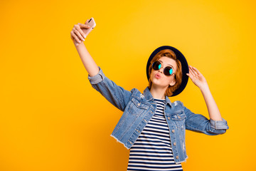 Close up photo beautiful foxy she her lady chic modern look telephone make take selfies send air kiss wear specs vintage hat casual striped t-shirt jacket jeans denim isolated yellow bright background