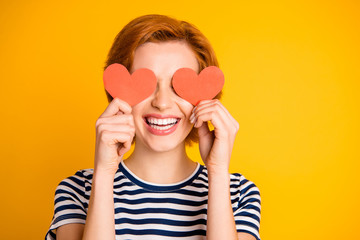 Close-up portrait of her she nice-looking attractive cheerful cheery optimistic girl closing eyes with two small little heart shapes hiding isolated over bright vivid shine yellow background