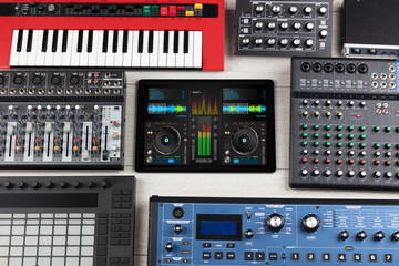 Mixing music on tablet with electronic music instruments concept
