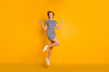 Fototapeta na wymiar Full length body size view portrait of nice cool lovely charming attractive cheerful cheery optimistic girl jumping up in air showing double v-sign isolated over bright vivid shine yellow background