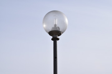 Street lamp against the blue sky.