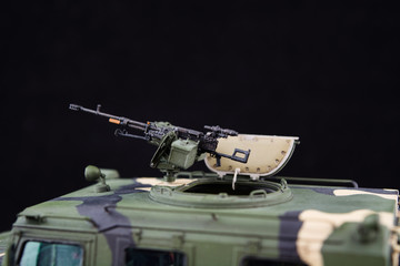 Russian military armored camouflage jeep Tiger. Closeup view. Plastic scale model on dark background