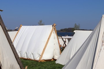 Old vikings tent made of cloth and wood in front of a blue sky