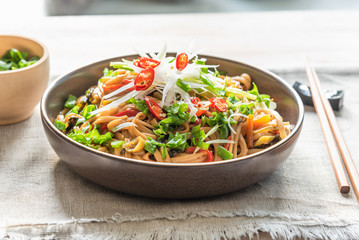 Traditional chinese vegetarian noodle chow mein on a plate with chopsticks