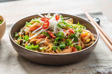 Traditional chinese vegetarian noodle chow mein on a plate with chopsticks