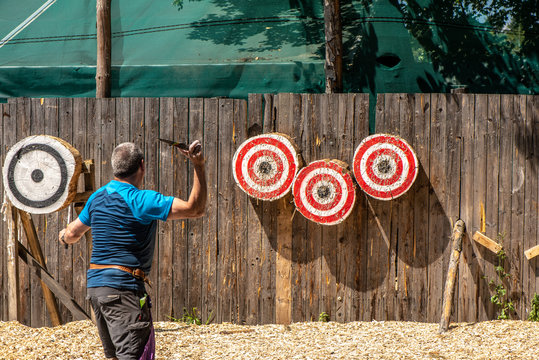 A Man Is Ready For Throwing Knife To The Target  On Competition.