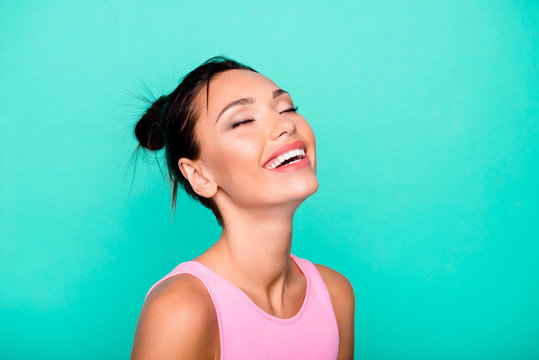Close up side profile photo beautiful she her lady trendy stylish hairdo toothy ideal appearance eyes closed overjoyed laugh wear casual pink tank-top outfit clothes isolated teal turquoise background