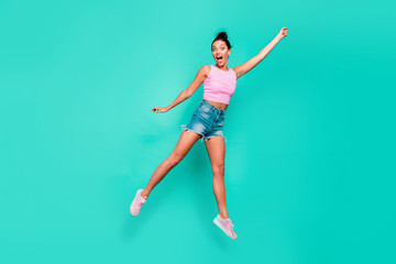 Fototapeta na wymiar Full length body size photo beautiful she her jump high trendy stylish hairdo pretend merry umbrella flight not believe wear casual pink tank-top jeans denim shorts isolated teal turquoise background
