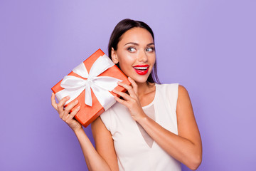 Close up photo beautiful amazing she her lady hold giftbox hands arms wondered look side empty space allure tempting lips pomade wear white formal-wear dress isolated violet purple background