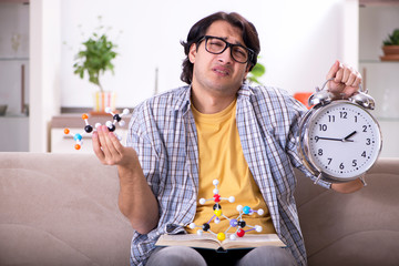 Young student physicist preparing for exam at home    