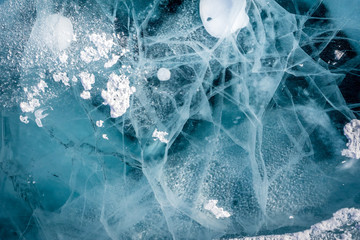 Network of cracks in thick solid layer of ice of a frozen Baikal lake in Siberia (Russia)
