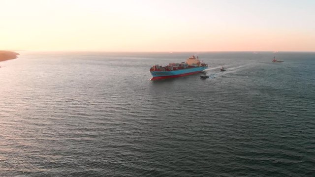 Large modern container ship moves along the route and arrives at the port of discharge - Top down Aerial
