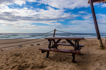 Cafe Terrace At The Beach in April, Under a Cloudy Blue Sky