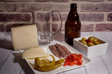 cheese board next to a beer