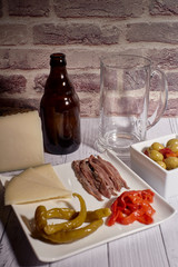 cheese board next to a beer