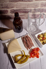 cheese board next to a beer