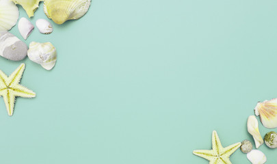 Composition of exotic seashells, oyster, starfish and lemon slices on white wooden background. Tropical summer vacation or sea food concept. Flat lay, top view. Marine design.