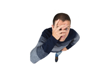 man peeking with hand on face on white background