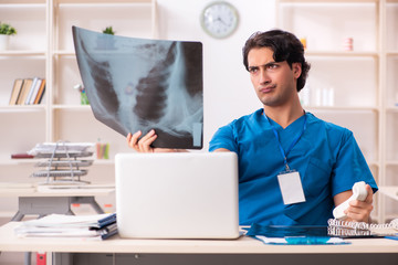 Young handsome doctor radiologist working in the clinic
