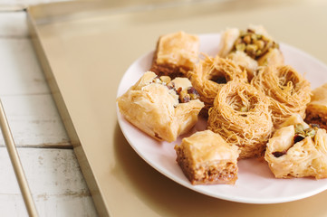 Assorted baklava served on a metal tray. Traditional arabic dessert