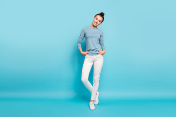Full length body size photo beautiful amazing she her lady stylish hairstyle look interested curious wondered toothy pretty wear casual white pants sweater pullover isolated blue bright background