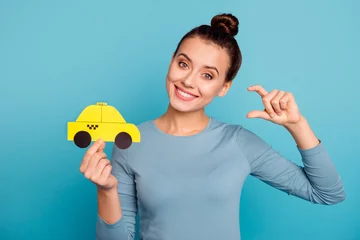 Fotobehang Portrait joy excited cheerful beautiful positive lady hipster hold hand yellow show advantage offer go call order uber stylish style trendy shirt beautiful hair hairstyle isolated blue background © deagreez