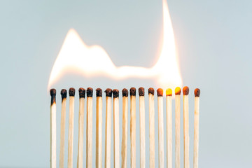 row of wooden matches, the fire swiftly moves from match to match