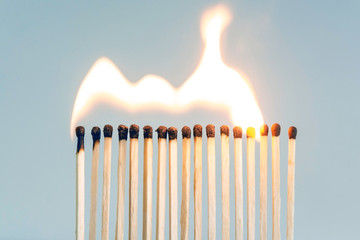 row of wooden matches, the fire swiftly moves from match to match