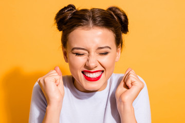 Close-up portrait of her she nice-looking attractive lovely cheerful cheery optimistic teen girl holding fists isolated over bright vivid shine yellow background