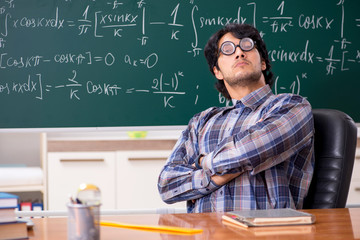Funny male math teacher in the classroom 