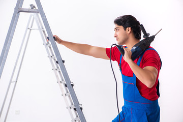 Young handsome contractor working indoors 