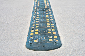 Fototapeta premium Obstacle on the road to reduce vehicle speed. Lying police officer.